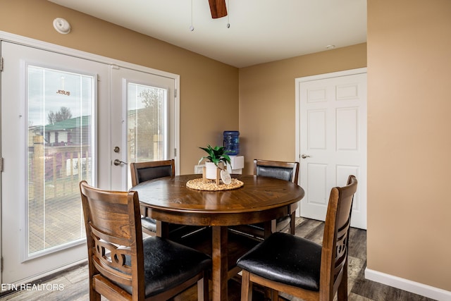 dining area featuring ceiling fan and dark wood-type flooring