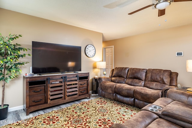 living room with ceiling fan and light wood-type flooring