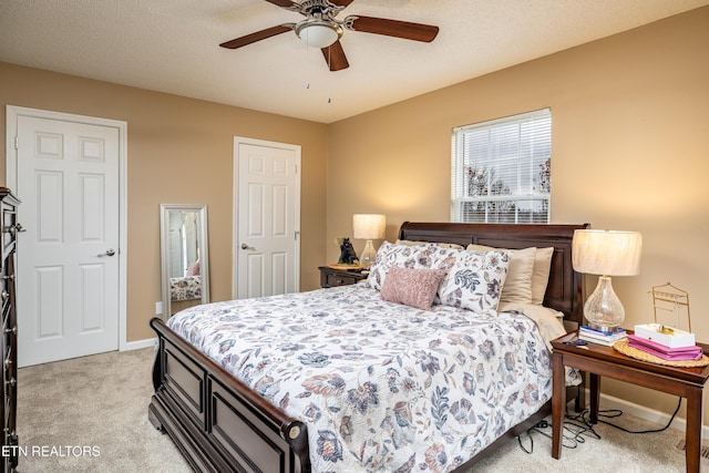 bedroom with ceiling fan and light colored carpet