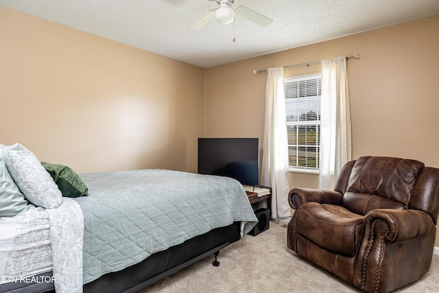 carpeted bedroom with a textured ceiling and ceiling fan