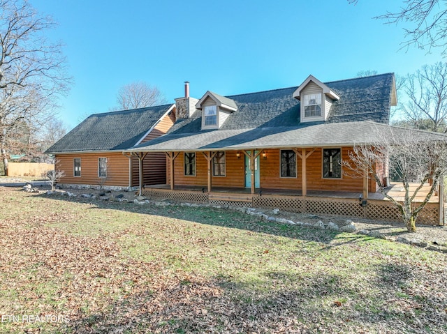 log-style house with a porch and a front lawn