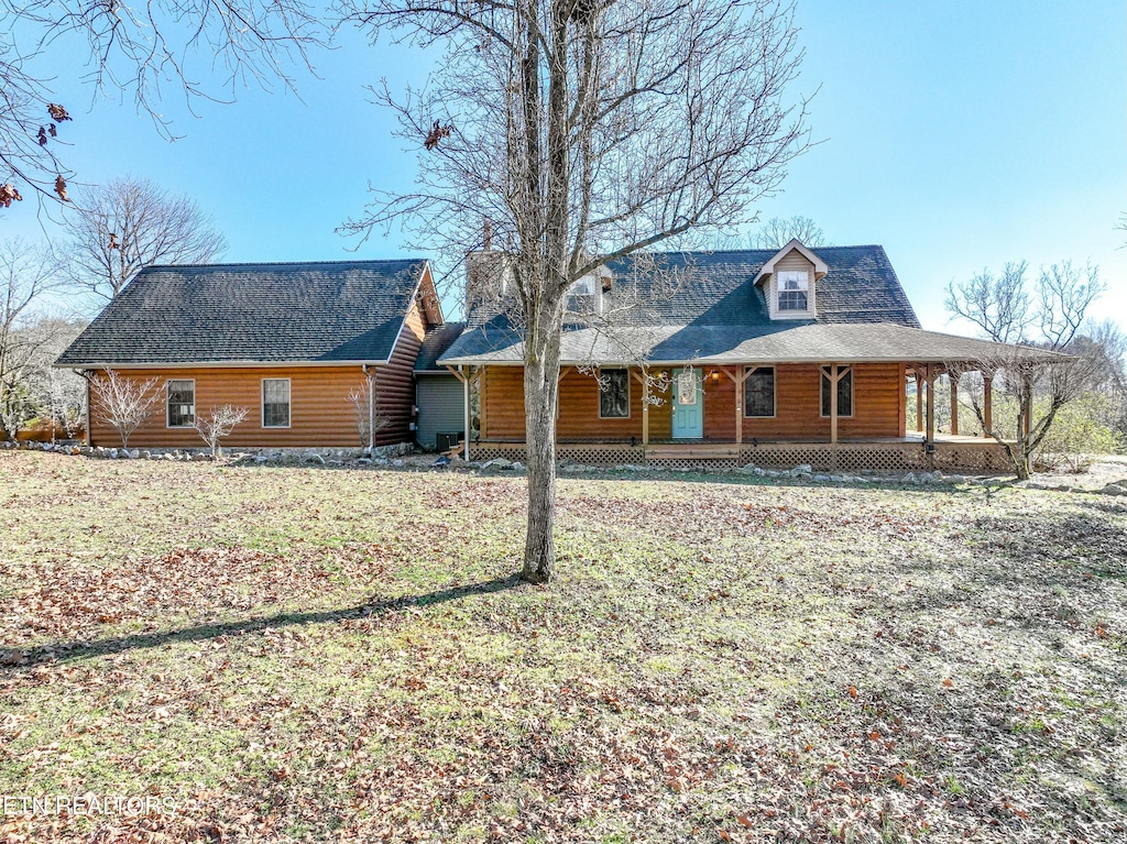 view of front of house with a front yard and covered porch