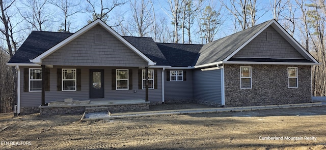 view of front of property with stone siding and covered porch