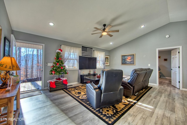 living room featuring light wood-type flooring, ceiling fan, and lofted ceiling