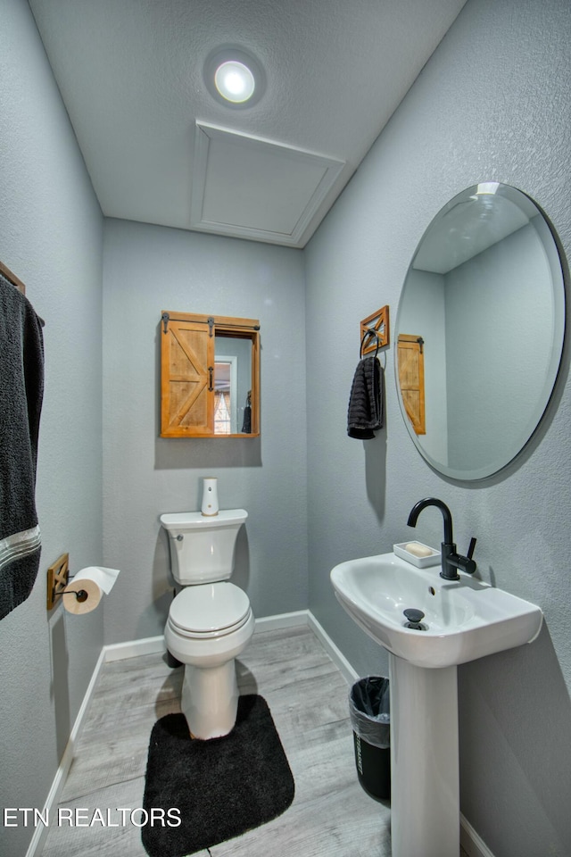 bathroom featuring hardwood / wood-style floors and toilet