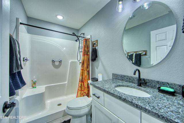 bathroom featuring vanity, toilet, and curtained shower