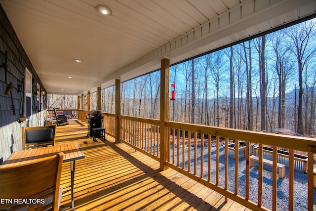 wooden deck featuring a grill