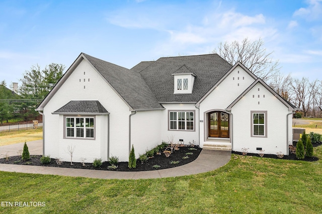 french country home with french doors and a front yard