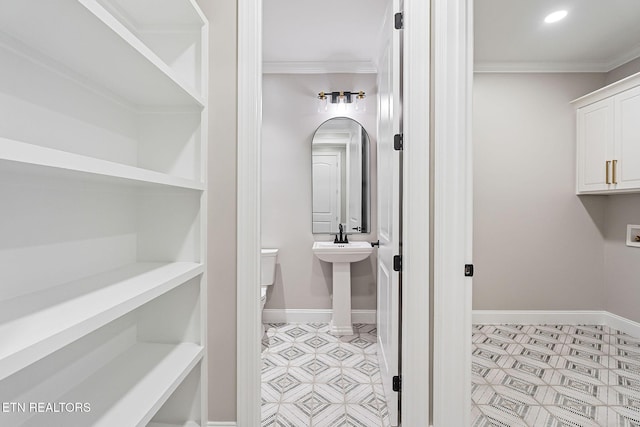 bathroom with sink and ornamental molding