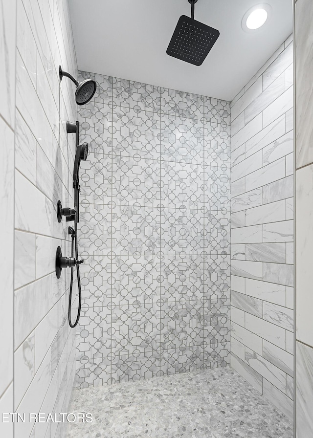 bathroom with a tile shower