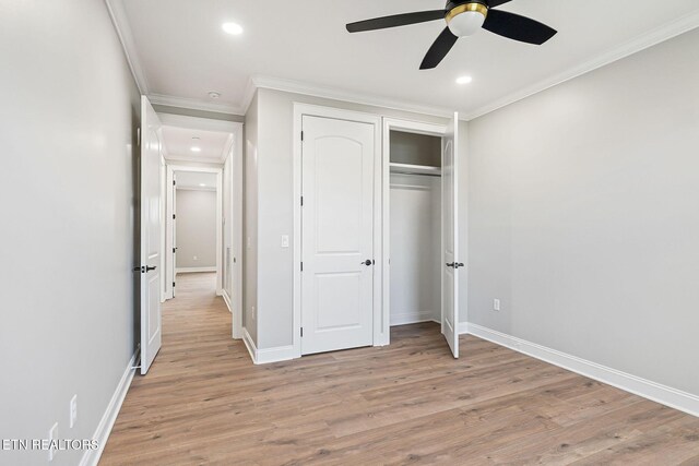 unfurnished bedroom with a closet, ceiling fan, crown molding, and light wood-type flooring