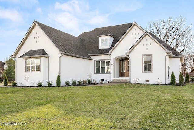 french provincial home with a front yard