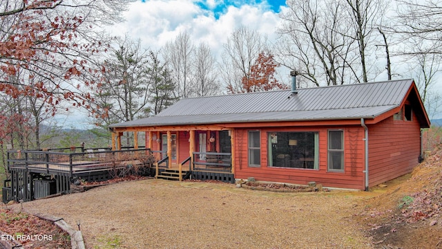 rear view of house featuring a deck