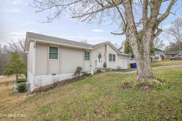 ranch-style home with a front yard and a garage