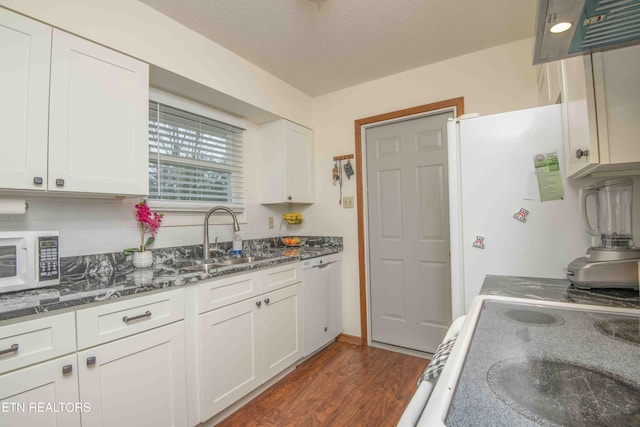 kitchen featuring white appliances, white cabinets, sink, a textured ceiling, and tasteful backsplash