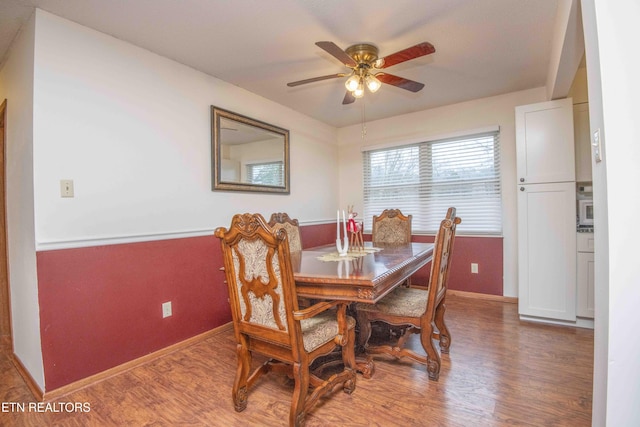 dining space featuring ceiling fan and hardwood / wood-style flooring