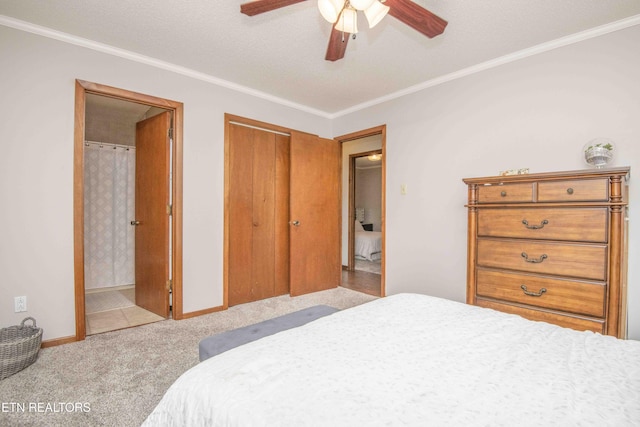 bedroom with ceiling fan, ornamental molding, light carpet, and ensuite bath