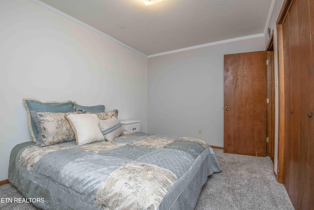 carpeted bedroom featuring a textured ceiling, a closet, and ornamental molding