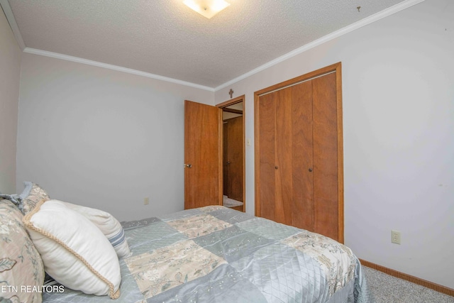 bedroom featuring ornamental molding, carpet floors, a textured ceiling, and a closet