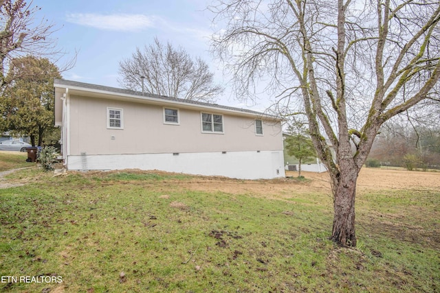 rear view of property with a lawn