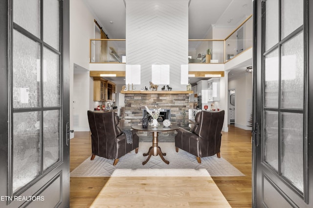 living room with a high ceiling and light hardwood / wood-style floors