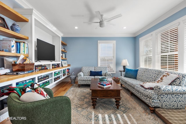 living room with ceiling fan, hardwood / wood-style floors, and ornamental molding