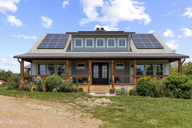 1430 Maple Ln, Greenback, TN 37742 - view of front of property with covered porch, french doors, board and batten siding, and roof mounted solar panels