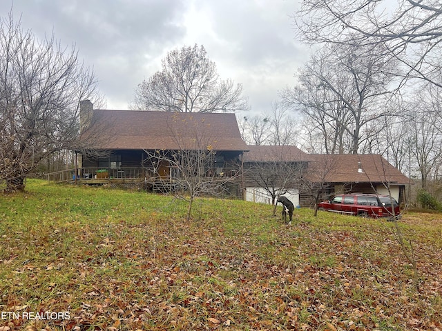 back of property featuring a garage