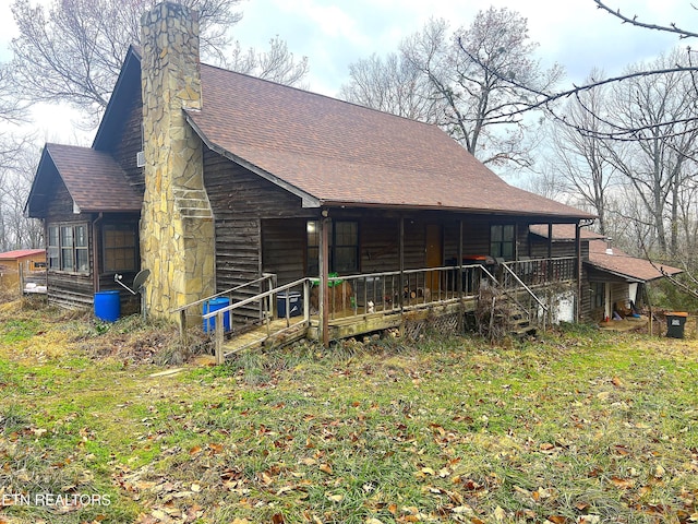 rear view of property featuring a porch