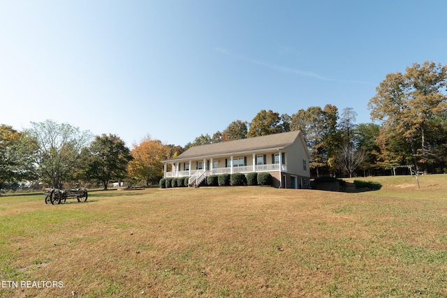 view of front of property with a front yard and a porch