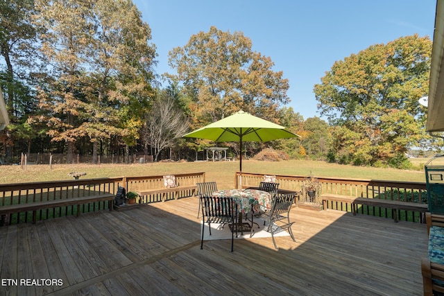 wooden terrace featuring a yard