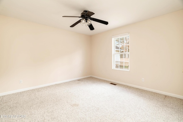 spare room featuring carpet and ceiling fan