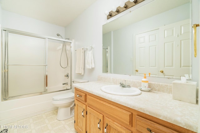 full bathroom with vanity, toilet, and bath / shower combo with glass door