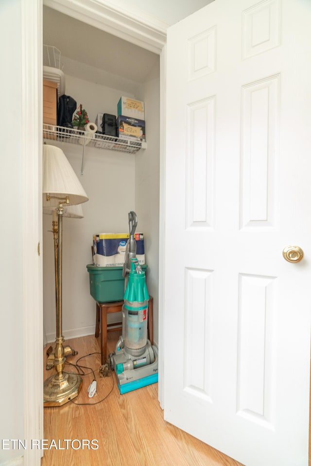 laundry area featuring hardwood / wood-style flooring