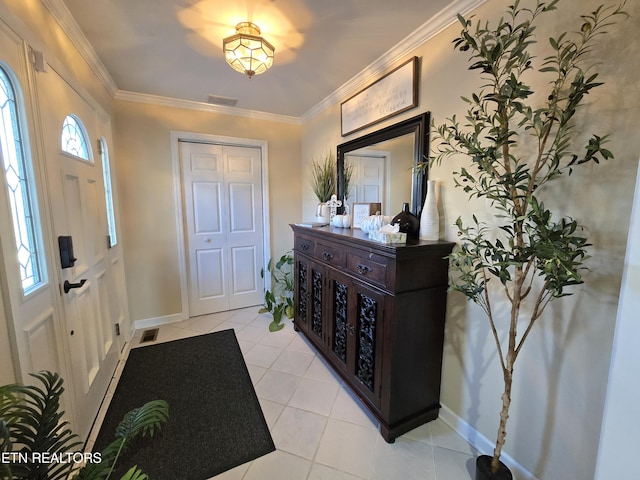 tiled foyer featuring crown molding