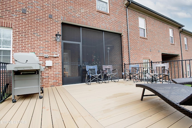 wooden terrace featuring grilling area