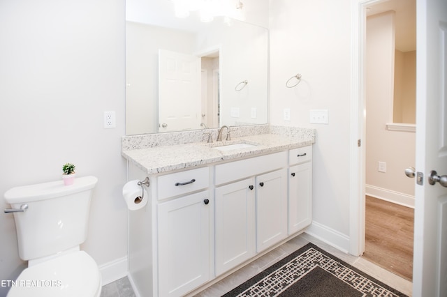 bathroom with tile patterned floors, vanity, and toilet