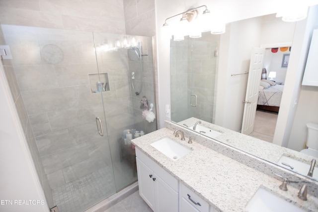 bathroom with vanity, toilet, and a shower with shower door