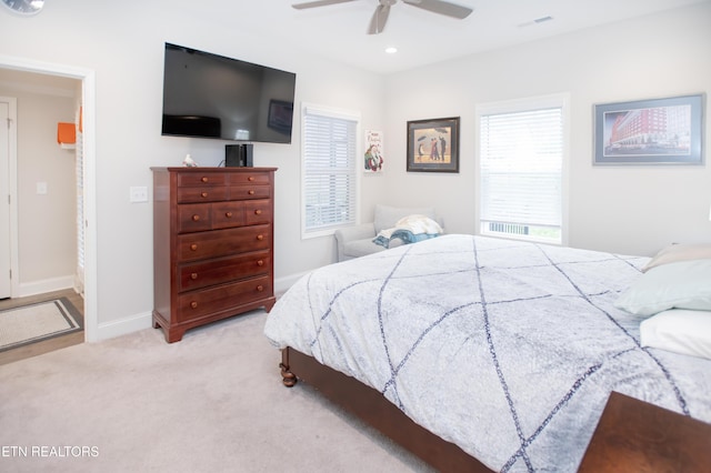 carpeted bedroom featuring ceiling fan and ensuite bathroom