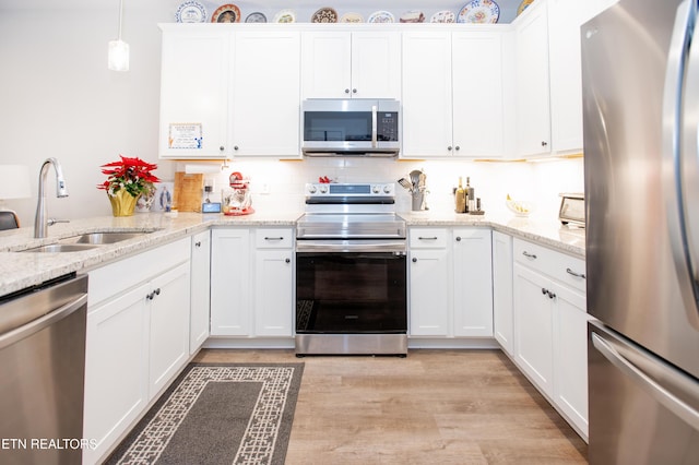 kitchen with white cabinetry, sink, and appliances with stainless steel finishes