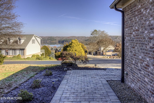 view of patio with a water view