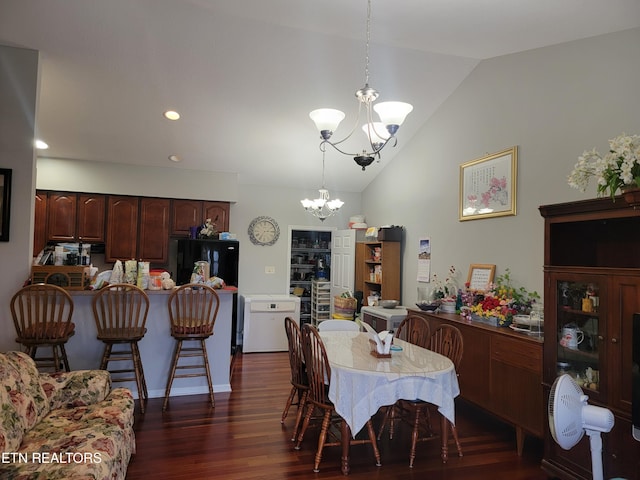 dining area with dark hardwood / wood-style flooring, an inviting chandelier, and lofted ceiling