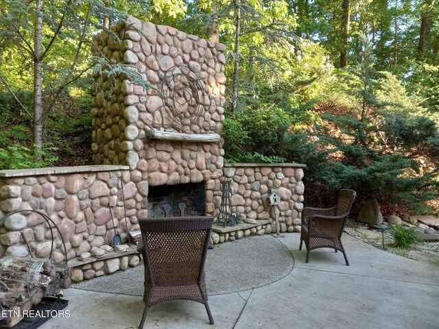 view of patio with an outdoor stone fireplace