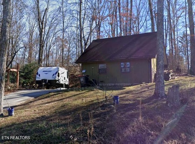 view of property exterior featuring a garage and an outdoor structure