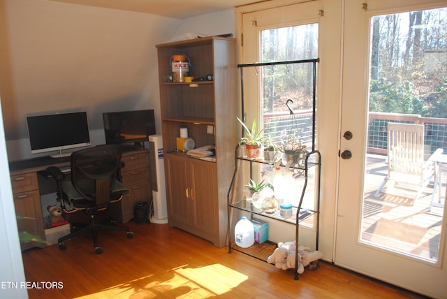 office space with light hardwood / wood-style floors and french doors