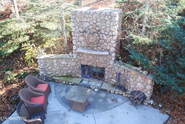 view of patio with an outdoor stone fireplace