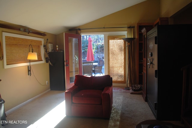 sitting room with dark carpet and vaulted ceiling