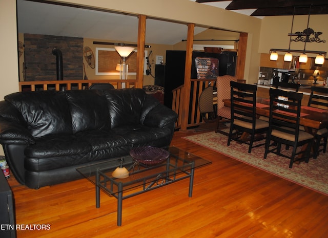 living room featuring hardwood / wood-style flooring and a wood stove