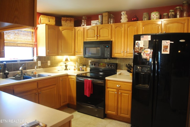 kitchen featuring tasteful backsplash, sink, and black appliances