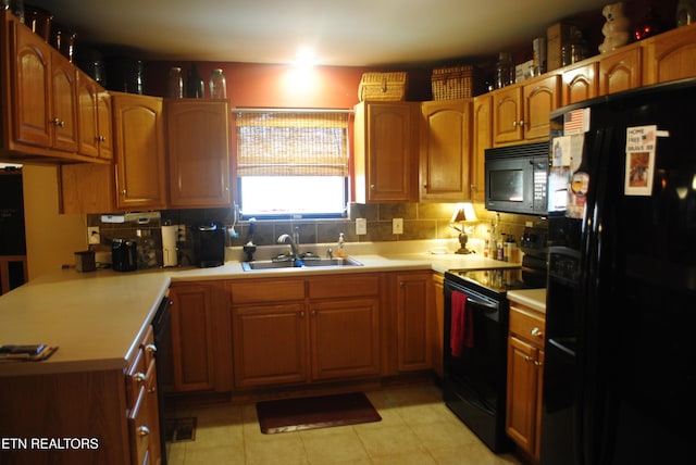 kitchen with tasteful backsplash, kitchen peninsula, sink, and black appliances